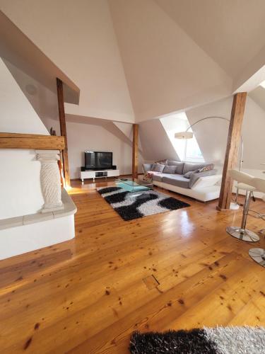 a living room with a couch and a tv at ShalalaLiving Apartments Mariazell in Mariazell