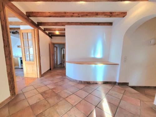 an empty living room with a stove in the middle at ShalalaLiving Apartments Mariazell in Mariazell