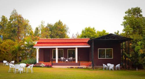 a small house with a lot of chairs in the yard at Eco Adventure Resorts Khhairabera in Bāghmundi