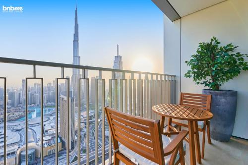 a balcony with a table and chairs and a view of the city at bnbmehomes - Downtown Views II - Tower 1 in Dubai