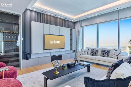 a living room with a couch and a tv at bnbmehomes - Downtown Views II - Tower 1 in Dubai