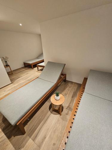 a room with two beds and a table in it at Hotel Bären in Adelboden