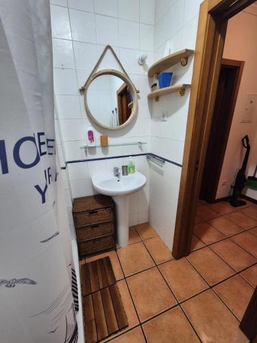 a bathroom with a sink and a mirror at Alqueva Beach House in Mourão