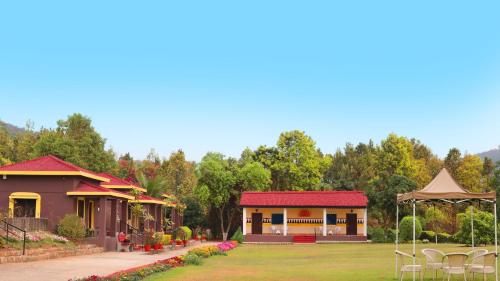 a house with a red roof and a garden at Eco Adventure Resorts Khhairabera in Bāghmundi