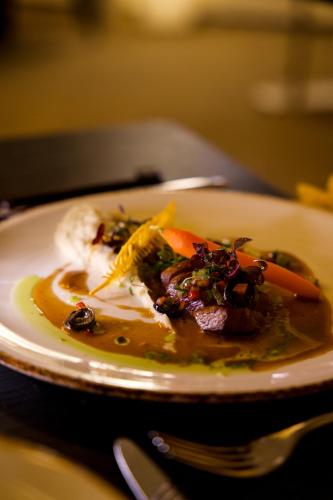 a plate of food with vegetables on a table at Le Chateau Des Thermes in Chaudfontaine