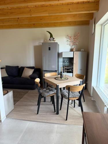 a kitchen with a table and chairs in a room at Náš sen - Domek in Svratouch