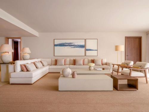 a living room with a white couch and a table at Fairmont La Hacienda Costa del Sol in Alcaidesa