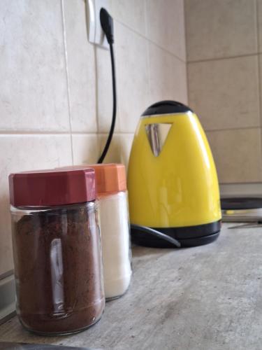 a group of containers sitting on a counter next to a toaster at Olive Tree Apartment in Asprovalta
