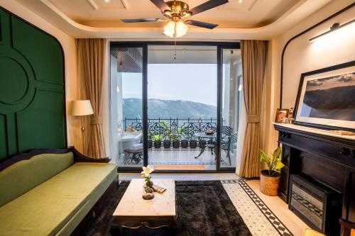 a living room with a couch and a fireplace at Polo Cherrapunjee Resort in Cherrapunji