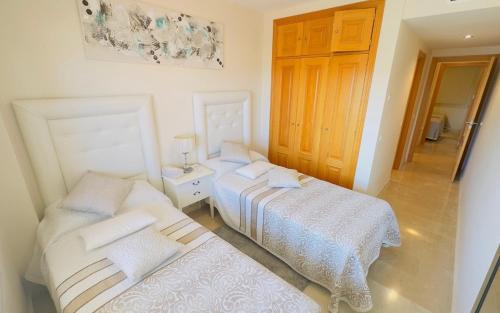 a bedroom with two beds and a door at Classypropety3 in Manilva