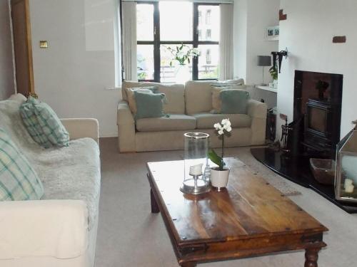 a living room with a couch and a coffee table at Four Seasons in Staveley