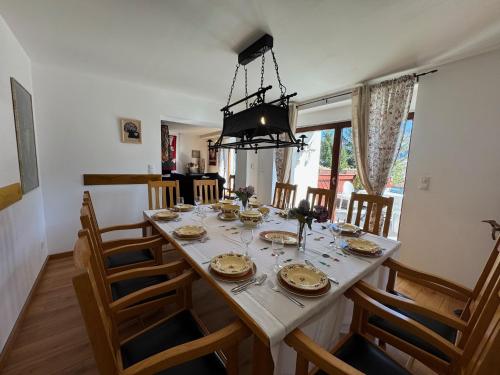 a dining room with a table with chairs and a chandelier at Willa Świerkowa 19 in Szczyrk