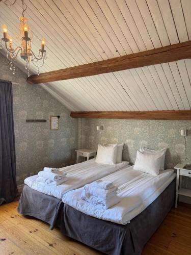 a large bed in a room with a ceiling at Asa Herrgård in Asa