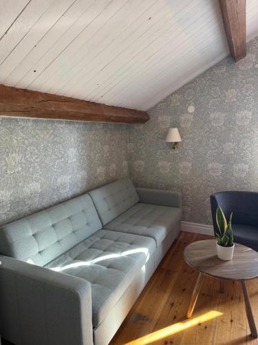 a living room with a couch and a table at Asa Herrgård in Asa