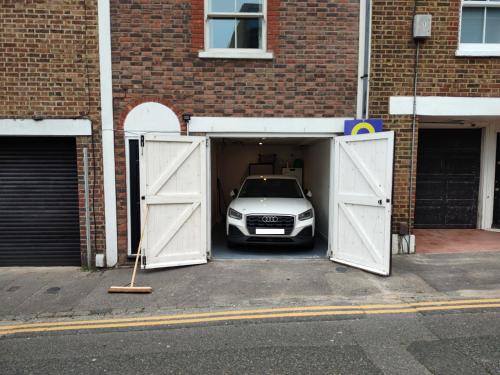 a car is parked inside of a garage at Modern, 2 Bdrm House with Parking Sleeps 6 Brighton Town Centre, North Laine in Brighton & Hove