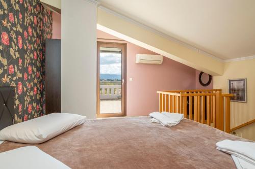 a bedroom with a large bed and a window at Areti Suites in Kathiana