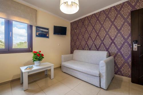 a living room with a chair and a table at Areti Suites in Kathiana