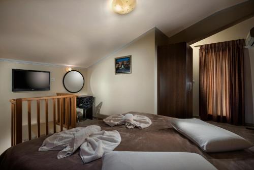 a bedroom with a bed with towels on it at Areti Suites in Kathiana