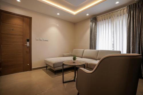 a living room with a couch and a table at TreeHouse Kambers in Belgaum