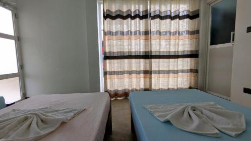 a bedroom with two beds and a window at Skyy Villa matara in Matara