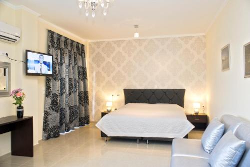 a bedroom with a bed and a couch at Areti Suites in Kathiana