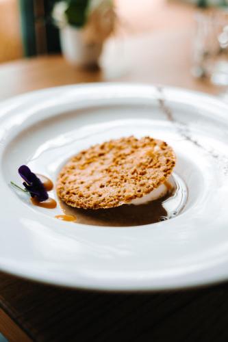 a white plate with a piece of food on it at Les Violettes Hotel & Spa in Jungholtz