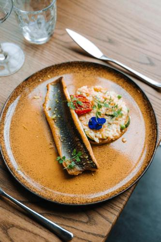 a plate of food with a sandwich on a table at Les Violettes Hotel & Spa in Jungholtz
