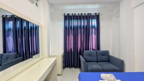 a living room with two chairs and a window at Skyy Villa matara in Matara