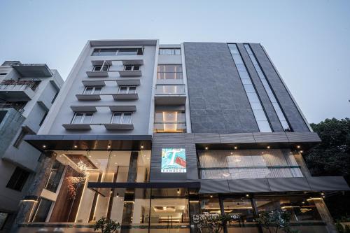a tall building with a store in front of it at TreeHouse Kambers in Belgaum