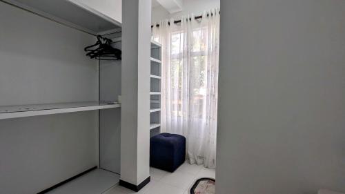 a room with a window with a blue suitcase in front of it at Skyy Villa matara in Matara
