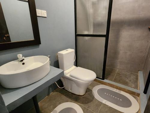 a bathroom with a sink and a toilet and a shower at Kemin Escapes - Yala in Tissamaharama