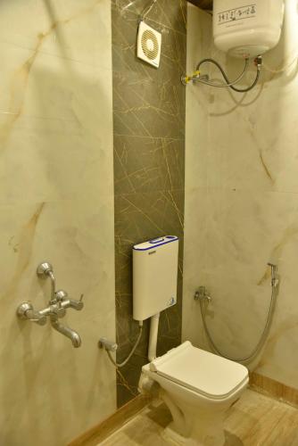 a bathroom with a toilet and a shower at Tarapith Tapabon Eco Resort in Tarapith