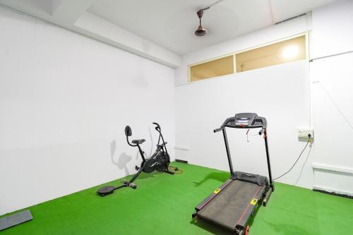 an empty room with a treadmill and a green floor at FabHotel The Botanica- Nr Hmwssb Kondapur section office-Masjid Banda, Kondapur in Kondapur