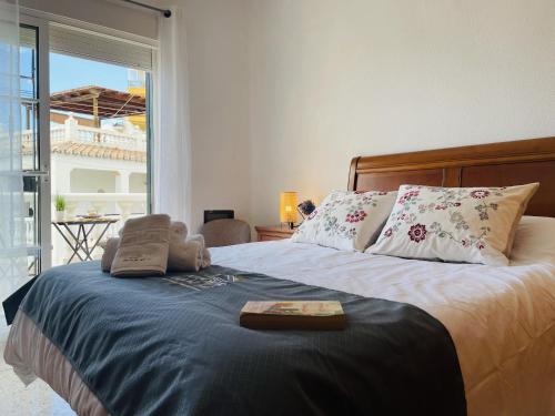 a bedroom with a bed with a tray on it at Casa Encanto de Nerja by At Home costa del sol in Nerja