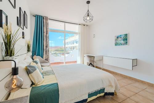 a bedroom with a large bed and a window at Marina Palace with Swimming Pool in Adeje