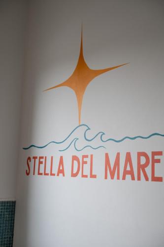 a bathroom with a sign on the wall of a room at Ostello Stella Del Mare in Varazze
