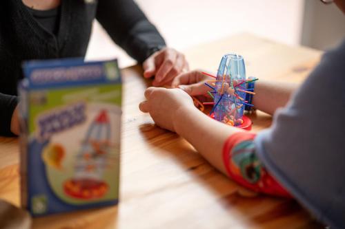 a child is playing with a toy on a table at Ostello Stella Del Mare in Varazze