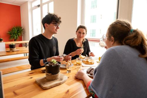 a group of people sitting around a table at Ostello Stella Del Mare in Varazze