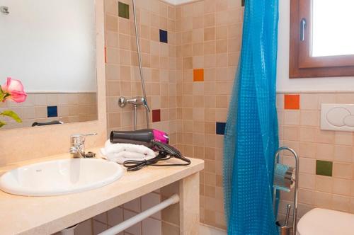 a bathroom with a sink and a shower at Mallorca beach home in Porto Cristo