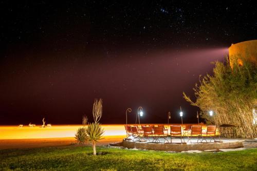 a group of chairs sitting under a night sky at Le Mirage Resort & Spa in Sesriem