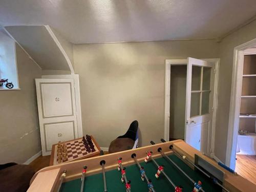 a living room with a pool table and chessboard at La Vigneronne in Saint-Floret