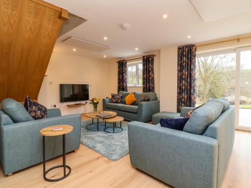 a living room with two couches and a tv at Hideaway in Great Torrington