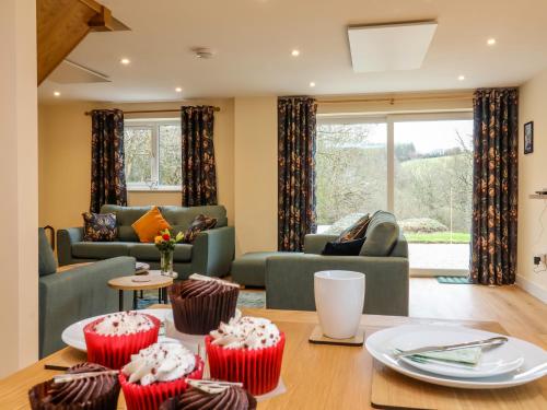 a living room with cupcakes on a table at Hideaway in Great Torrington
