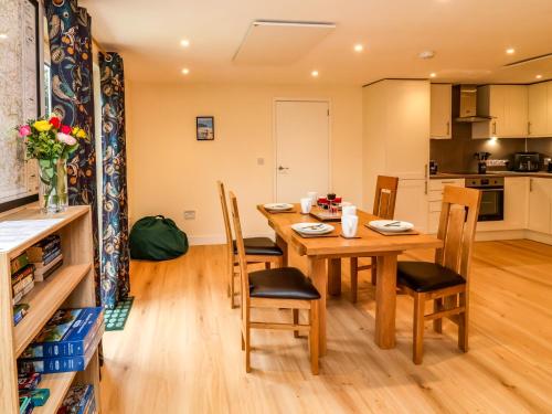 a kitchen and dining room with a wooden table and chairs at Hideaway in Great Torrington