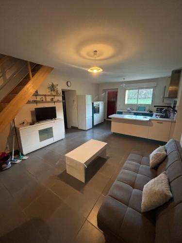 a large living room with a couch and a table at Gîte de Raynal in Les Junies
