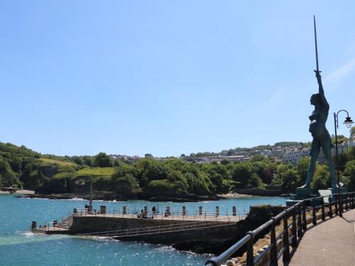 a bridge over a body of water with a statue at Hideaway in Great Torrington