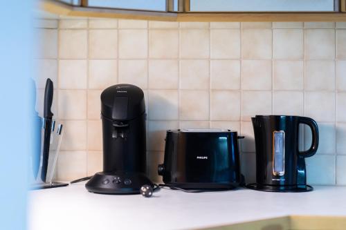 two coffeemakers sitting on a counter in a kitchen at homy MontaVista - 300m zur Golmerbahn in Vandans