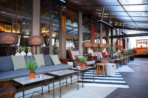 a lobby with couches and tables in a building at Brach Paris - Evok Collection in Paris