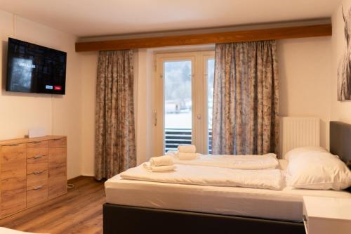 a bedroom with a large bed and a window at homy MontaVista - 300m zur Golmerbahn in Vandans