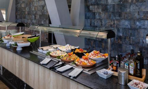 a buffet line with dishes of food and drinks at Catalonia Las Vegas - Adults Only in Puerto de la Cruz